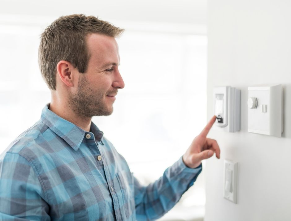 Man adjusting the thermostat